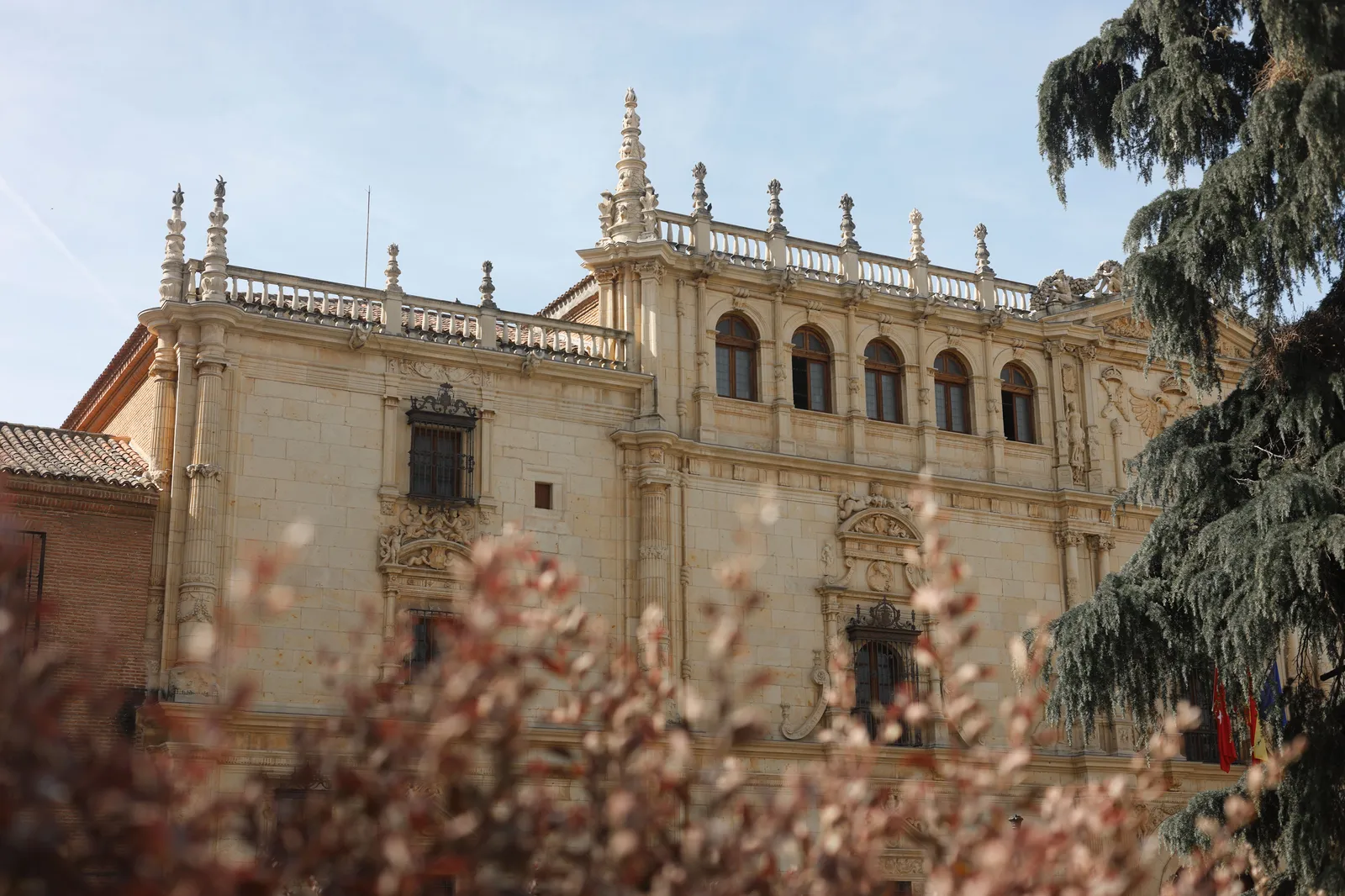 The intricately carved plateresque stone facade of the historic university building in Alcala de Henares, Spain