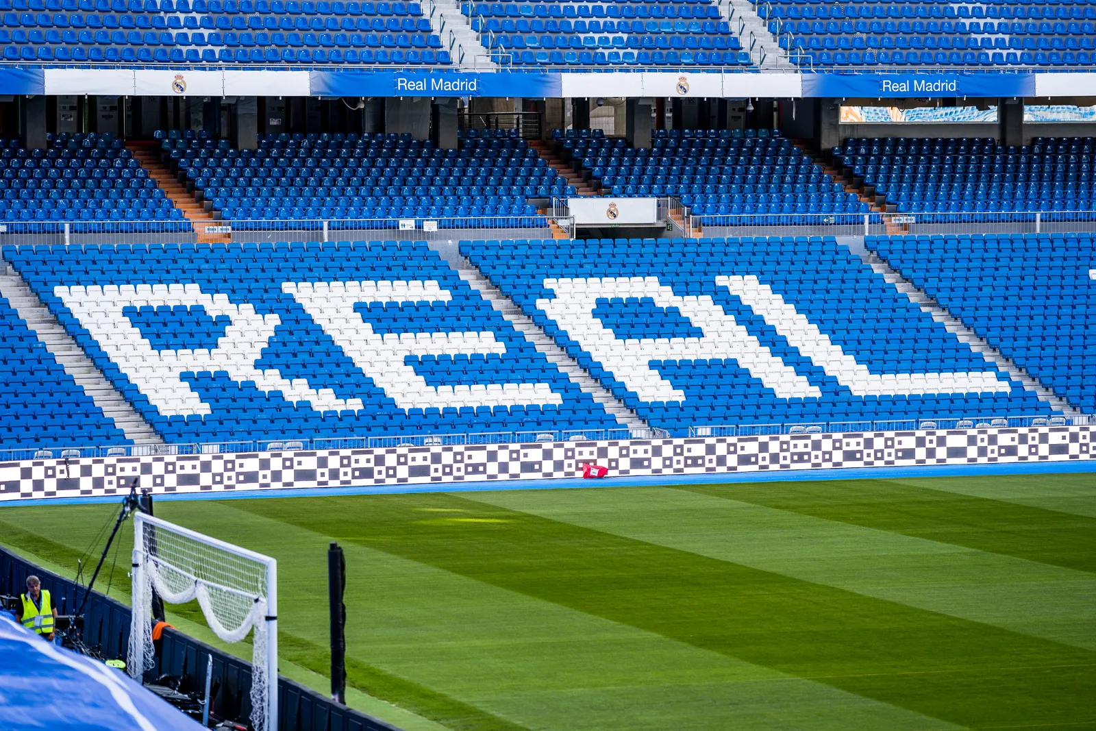 The exterior of the rebuilt Santiago Bernabéu stadium in Madrid lit against the sky