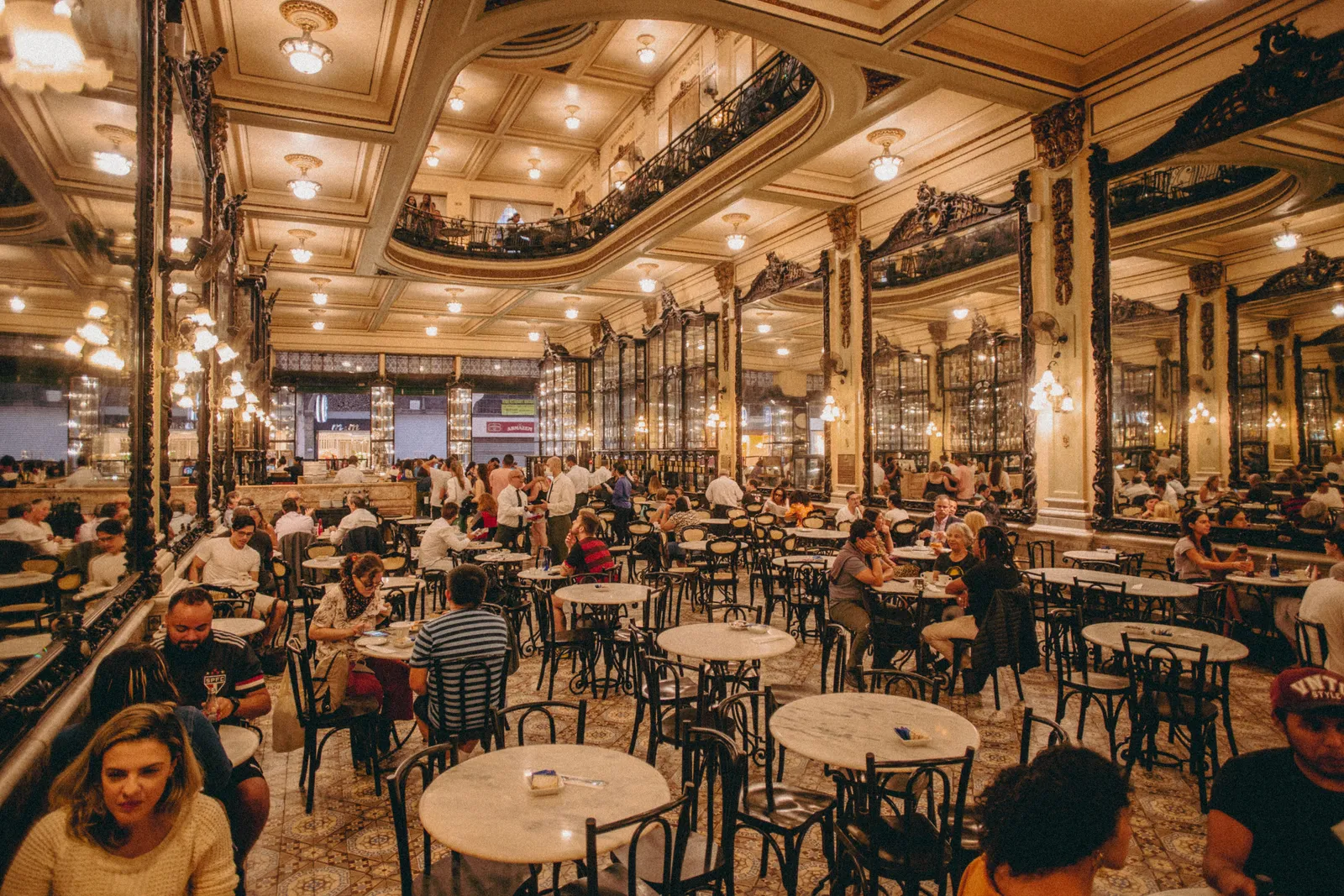 The interior of a grand historic cafe with marble tables in Madrid, Spain