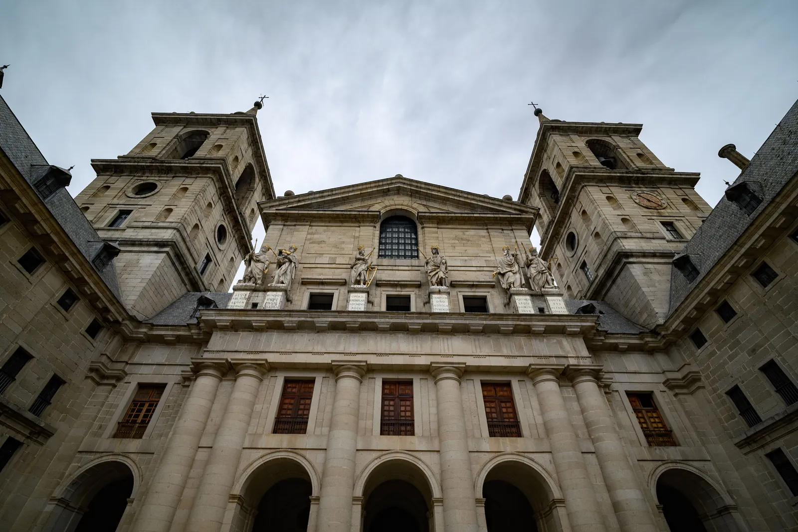 The grey granite facade and towers of the monastery of El Escorial near Madrid, Spain