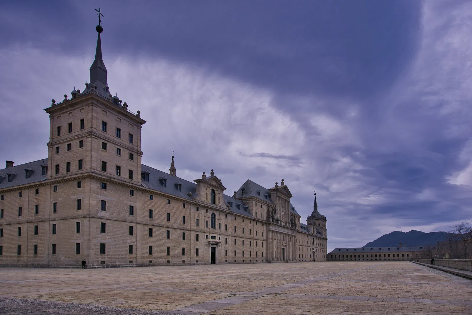 The full monastery complex of El Escorial seen from a distance with the sierra behind, Spain