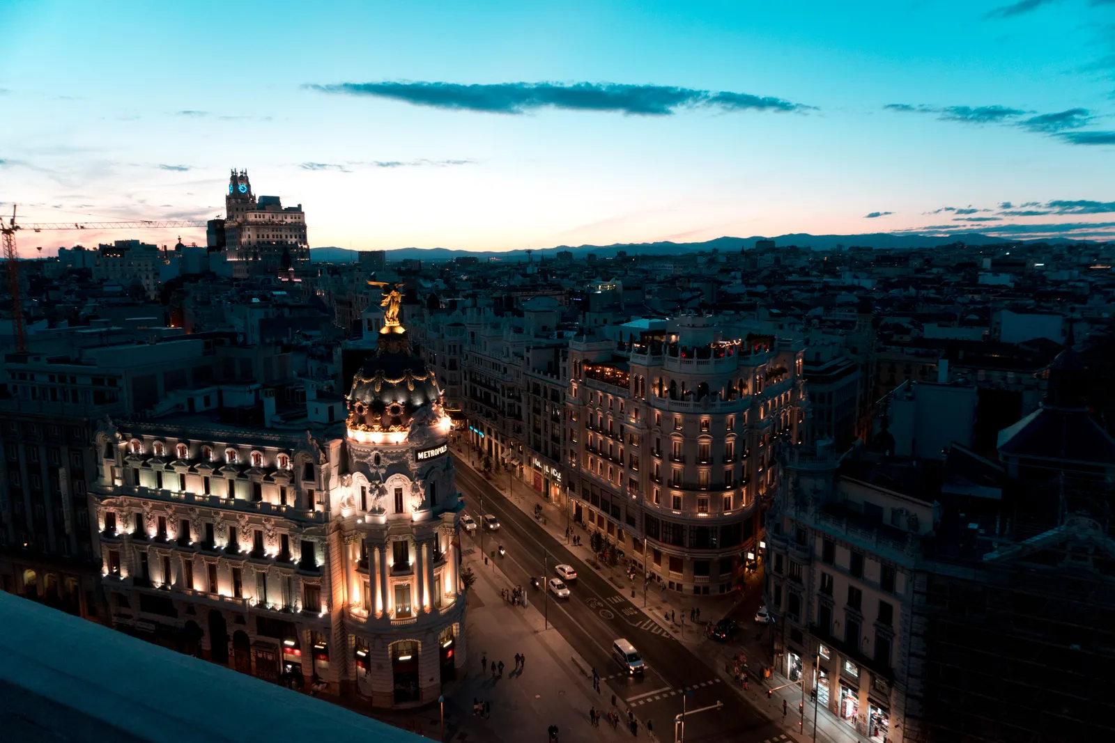The Metropolis building and Gran Via seen from above at dusk in Madrid, Spain