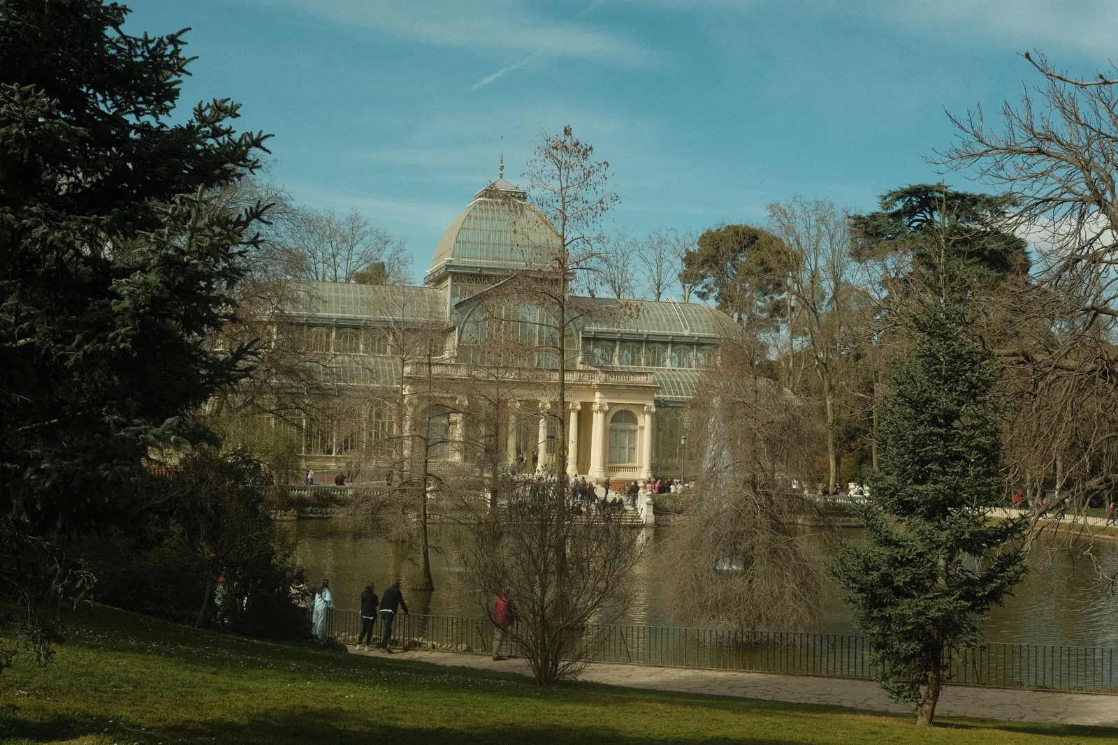The glass and iron Crystal Palace among trees in the Retiro park in Madrid, Spain