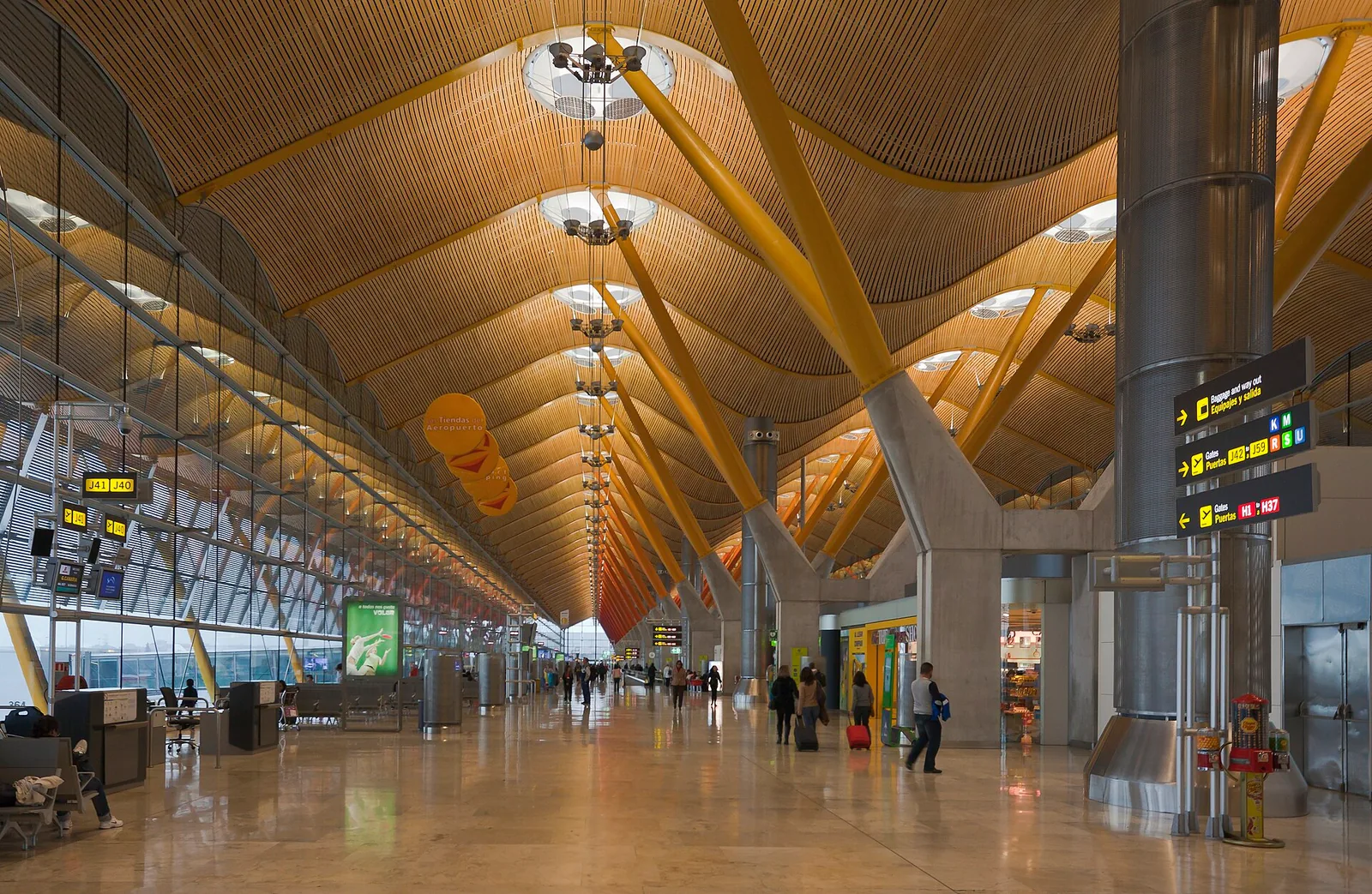 The wide concourse and bamboo-clad roof of Terminal 4 at Madrid Barajas airport in Spain