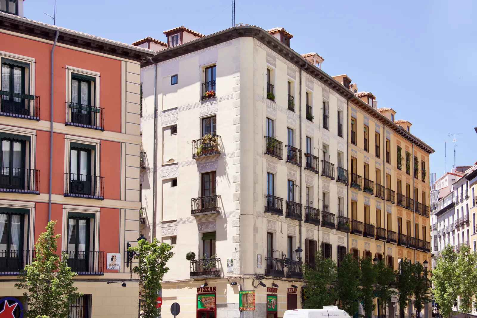 A narrow atmospheric street with tapas bars and hanging signs in central Madrid