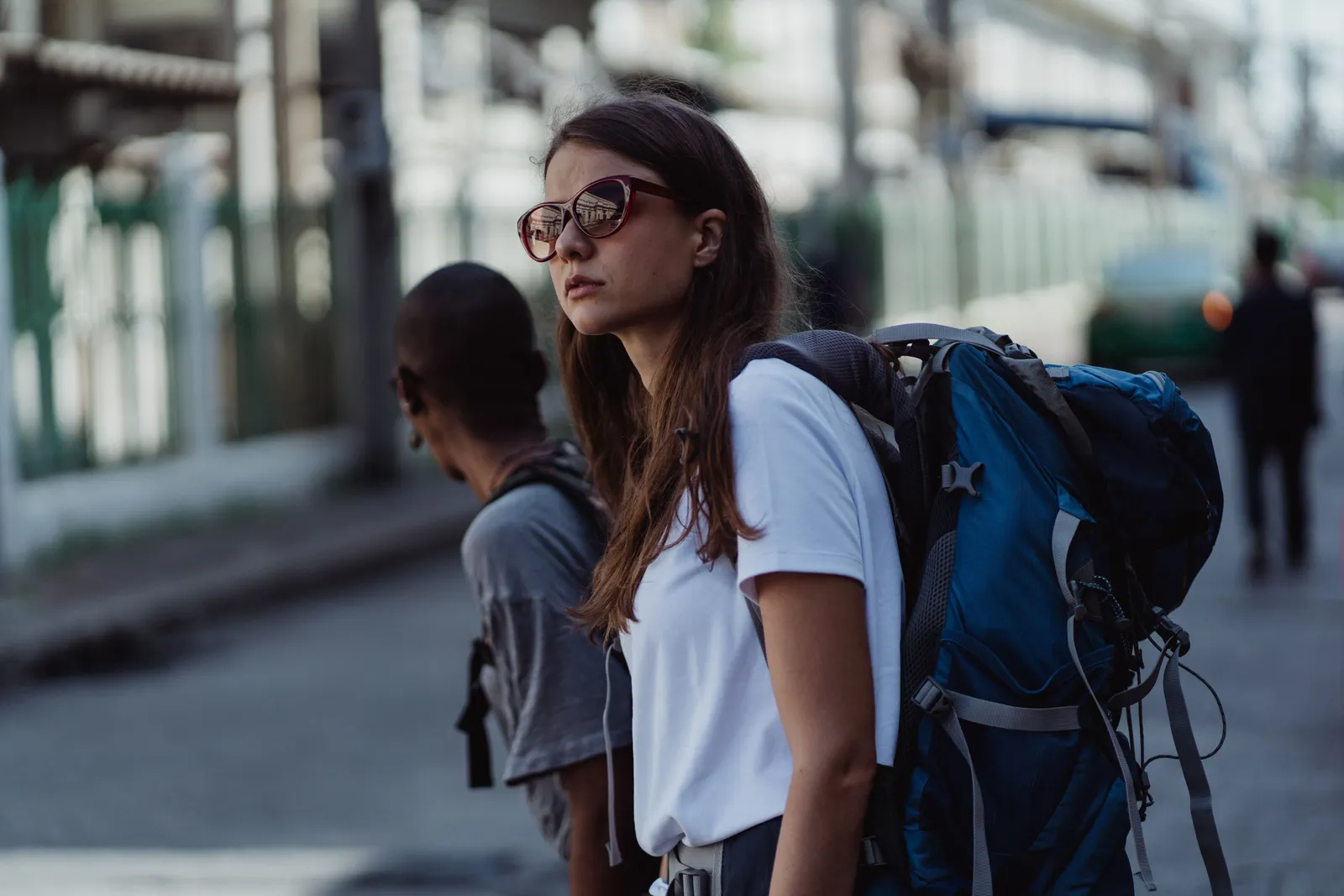 A traveller with a backpack walking along a street in Madrid, Spain