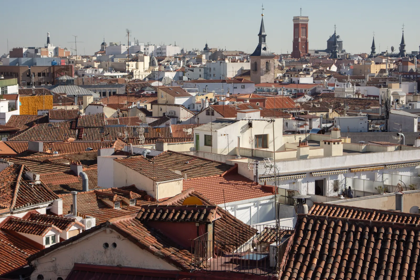Madrid rooftops in daylight with the towers of the old city on the skyline