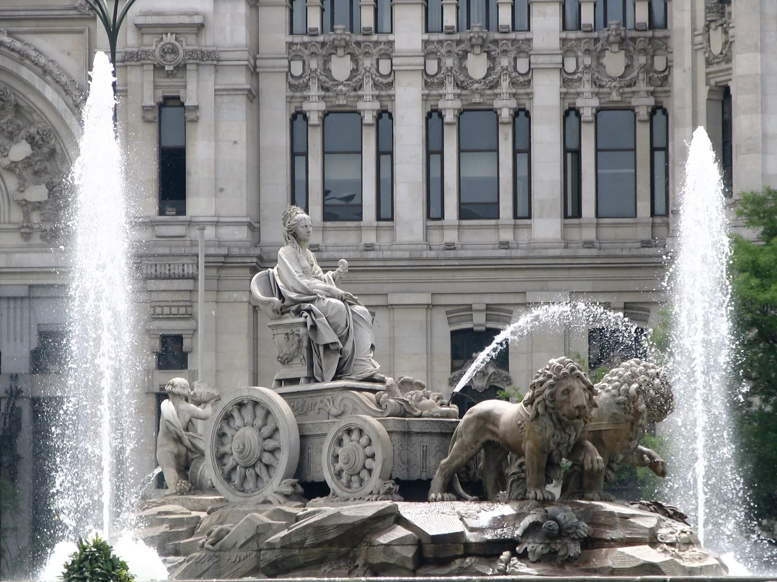 The Cibeles fountain playing in bright sunlight in Madrid, Spain