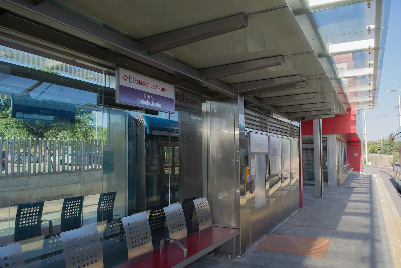 A commuter train waiting at a station platform in the Madrid region of Spain