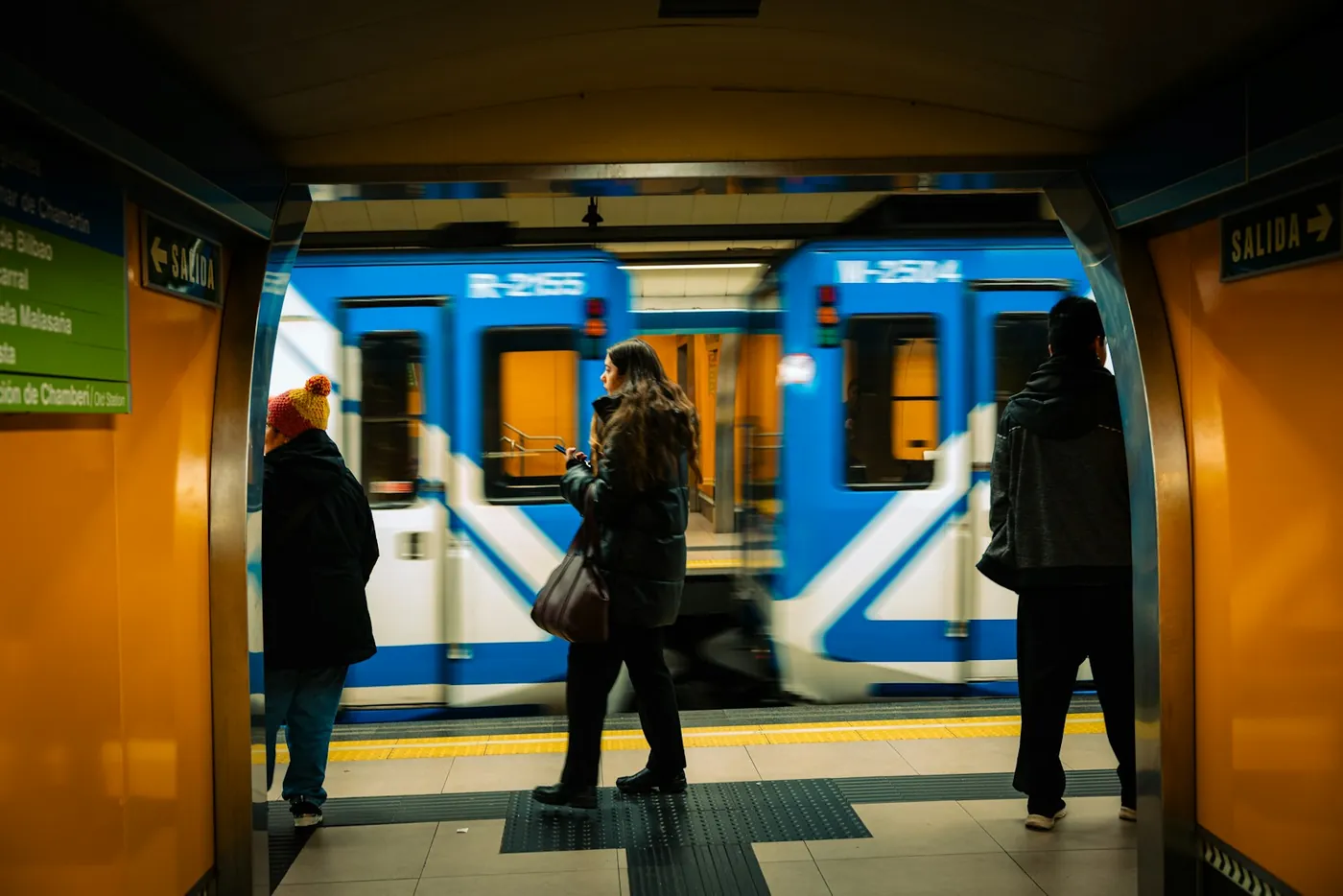 A busy metro platform in Madrid with commuters boarding a train, Spain