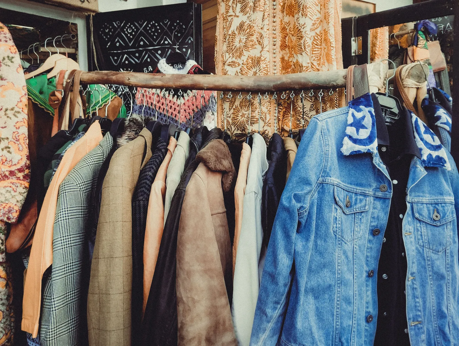 Rails of second hand coats and denim jackets inside a vintage clothing shop in Madrid, Spain