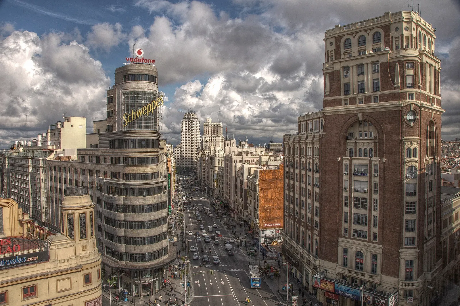 The Gran Via avenue in Madrid, Spain, lined with early twentieth-century buildings under a clear sky