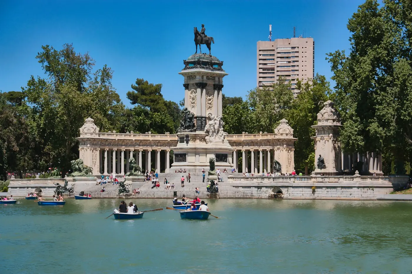 Children rowing a boat on the Retiro Park lake in Madrid, near the Alfonso XII monument, Spain