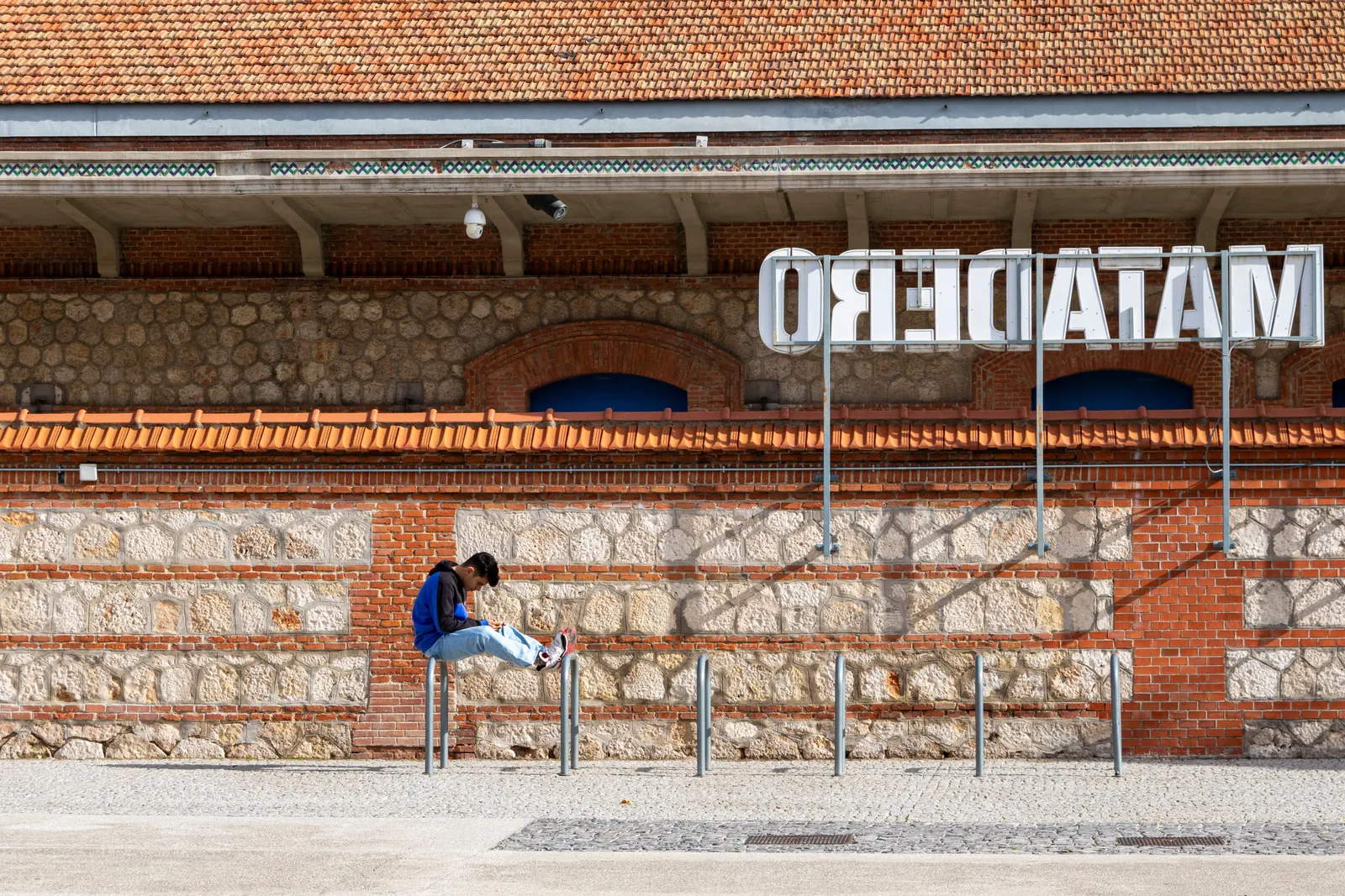 The red brick Neo-Mudejar facade of a converted former slaughterhouse building at Matadero Madrid beside the Manzanares river, Spain