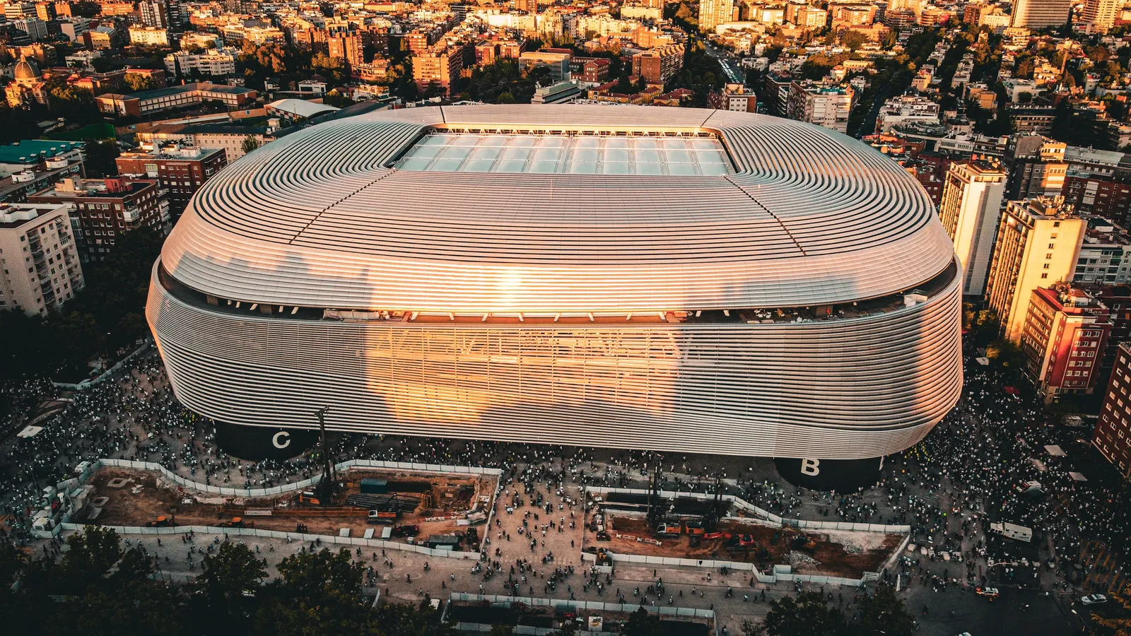 An aerial view of a large football stadium in Madrid in evening light