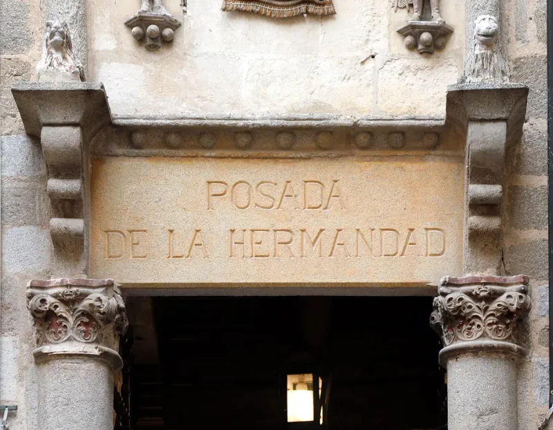 The carved stone gateway of the Posada de la Santa Hermandad in Toledo with its name cut into the lintel