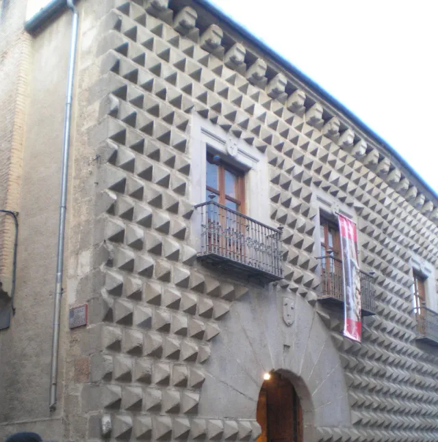 A stone facade entirely covered with protruding diamond shaped blocks