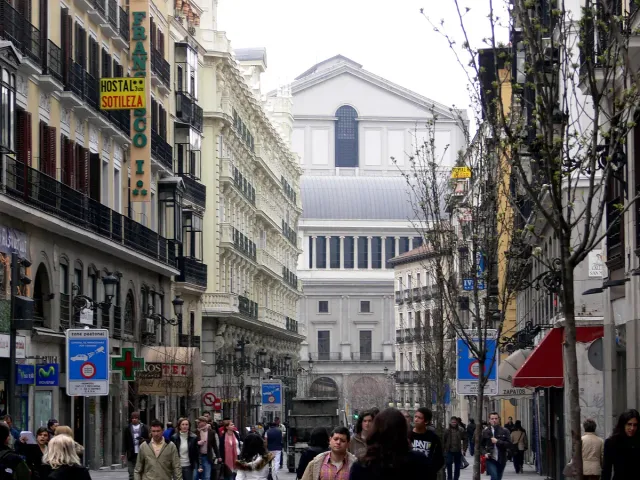 A street running down towards a large neoclassical building with a columned front at its end