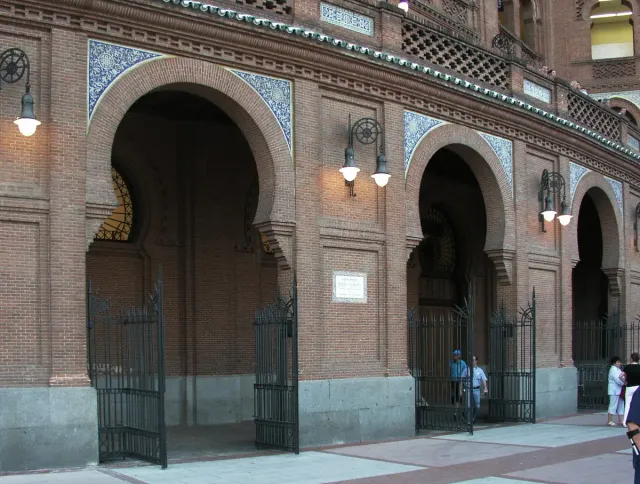 A Neo Mudejar brick facade with arched gateways and tiled decoration