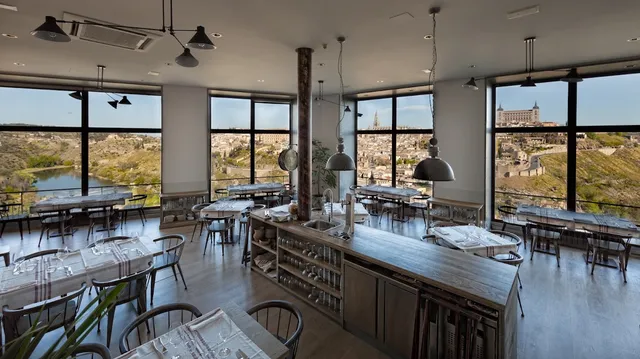 A restaurant hall with glass walls facing the old city and the river below it