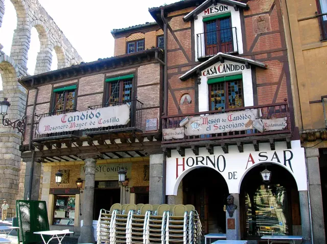 An old tavern house with timber beams, stone and tile signs and small square windows