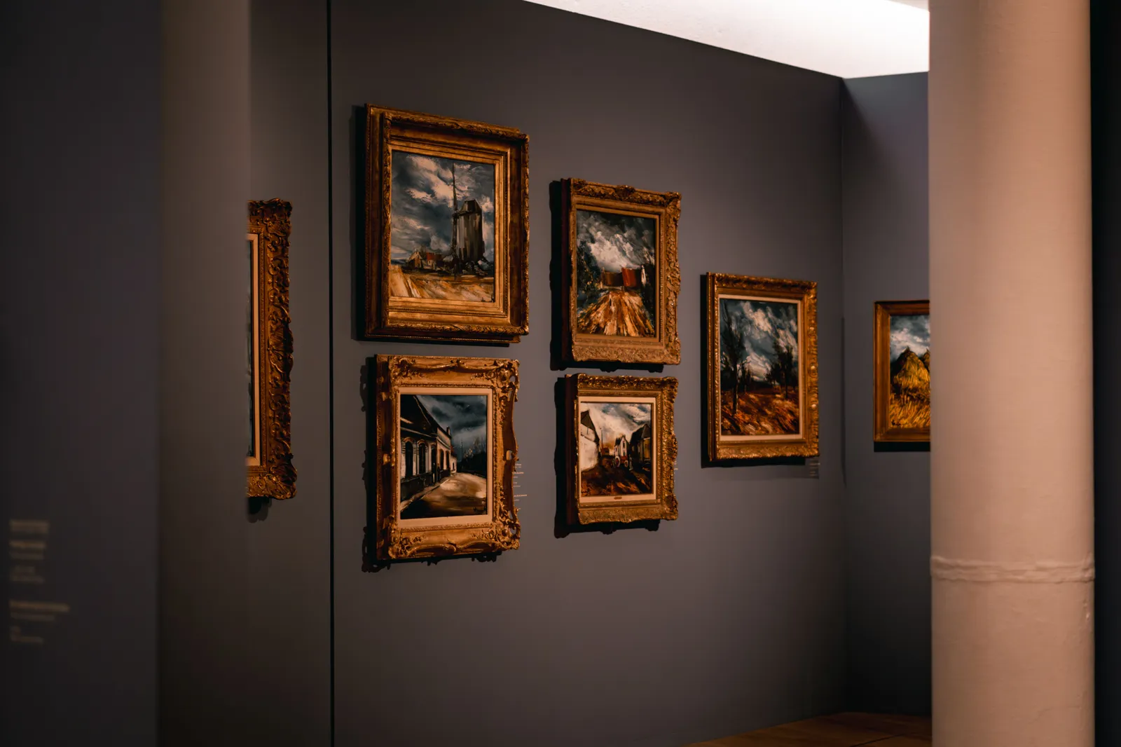 A gallery wall hung with gilt-framed paintings in a Madrid museum, Spain