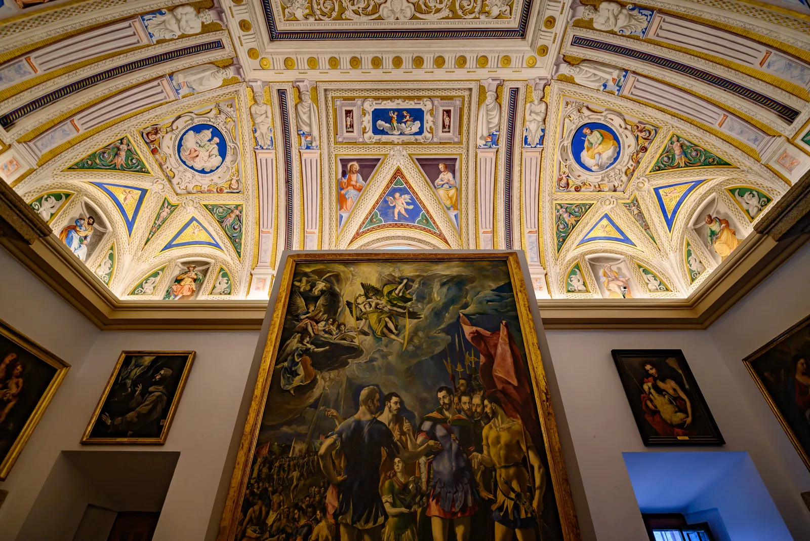 An ornate gallery interior hung with paintings in the Prado Museum, Madrid, Spain