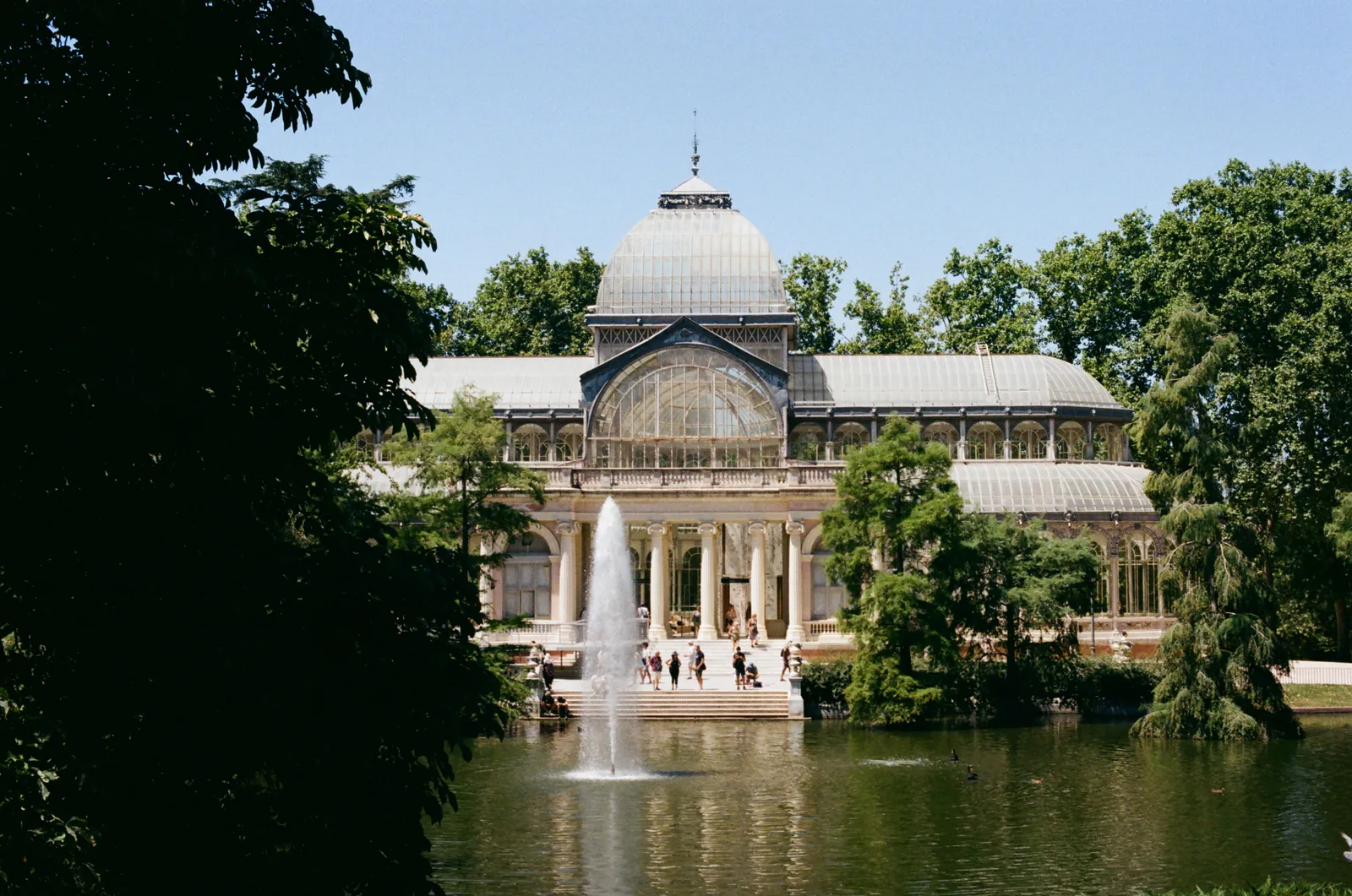 The Crystal Palace glass pavilion beside its pond in Retiro Park, Madrid, Spain