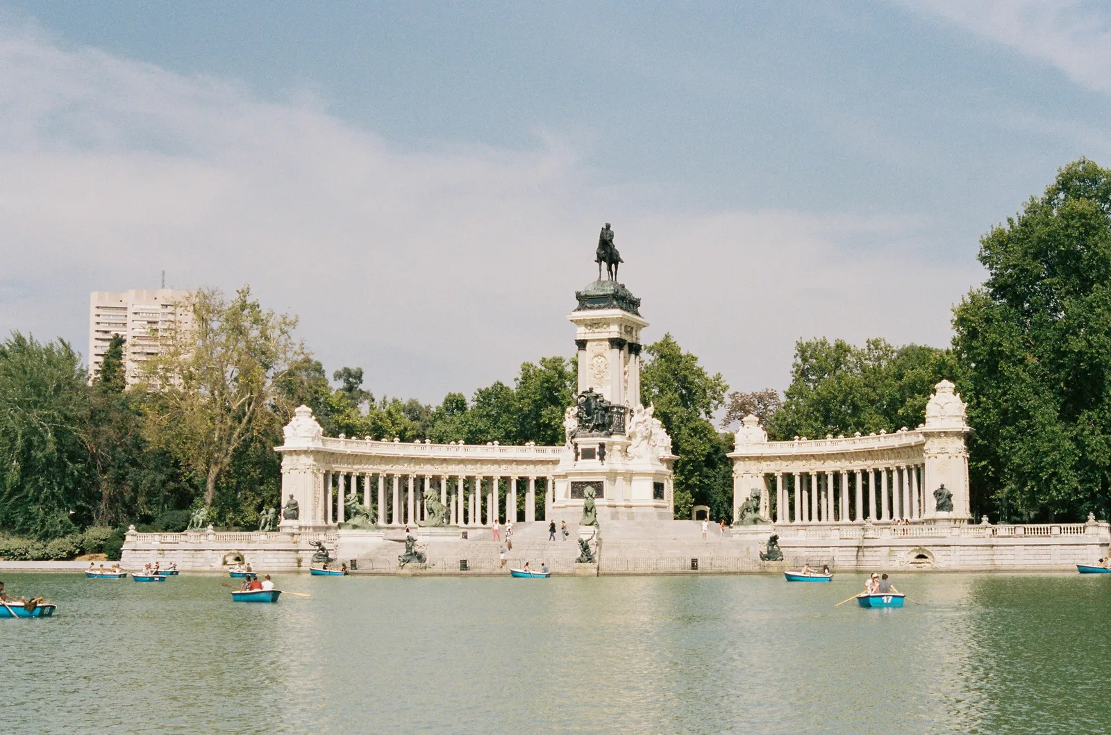 Rowing boats and the colonnade of the Alfonso XII monument on the Retiro lake, Madrid, Spain