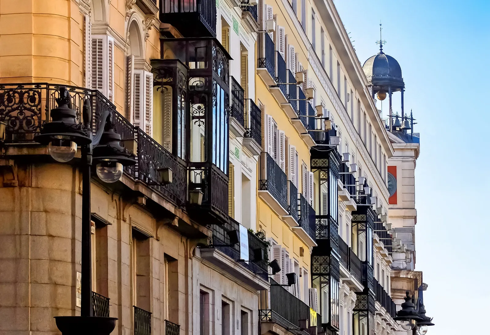 elegant nineteenth century apartment buildings in Madrid Spain with boutique shop windows at street level in daylight