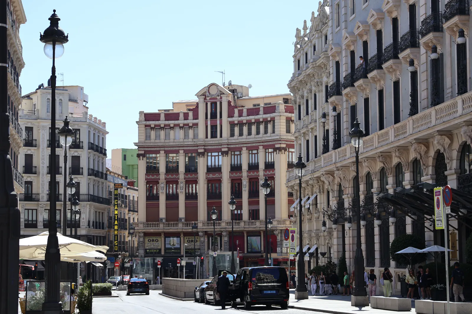 A wide avenue lined with shops and grand buildings in central Madrid, Spain