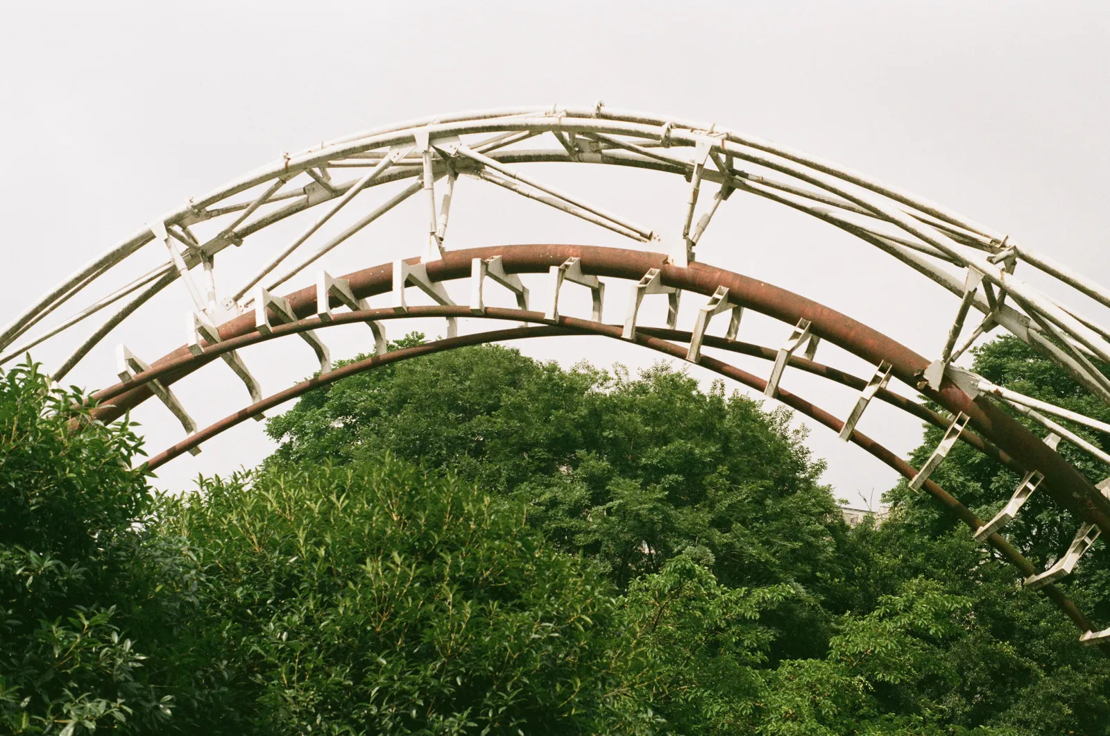 A roller coaster loop rising above the treetops at a theme park south of Madrid, Spain